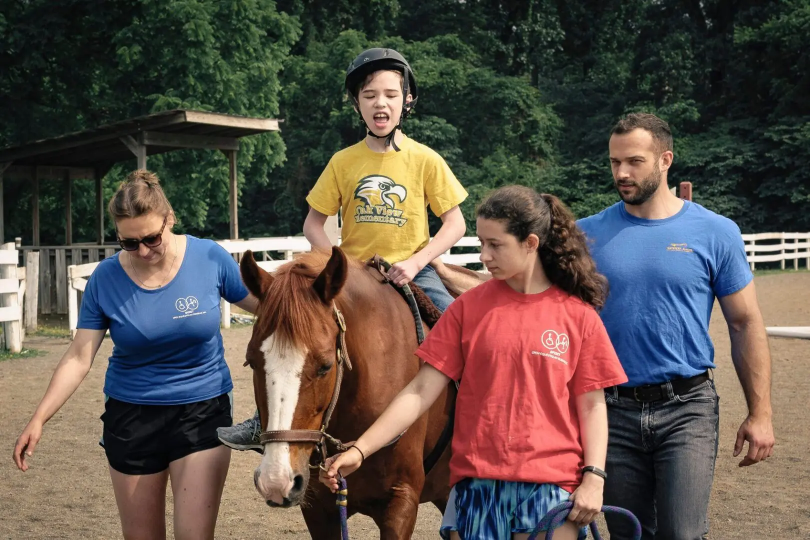 Two children, two adults, and a horse